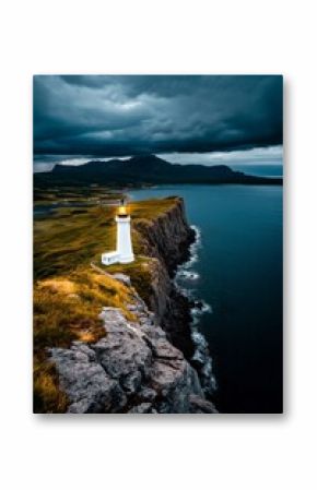 Light From the Lighthouse Guides Ships Along the Rugged Coast Under Dark Skies