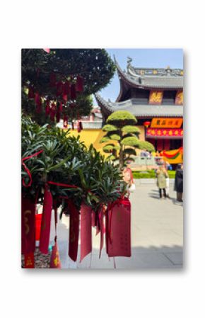 Shanghai, China. Red Chinese prayer tags hanging from a tree. Temple Of the Town God, Chenghuang Miao