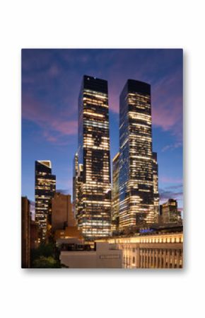 Hudson Yards skyscrapers in Manhattan at dusk. Illuminated urban skyline with office towers and modern architecture in New York City’s Midtown West