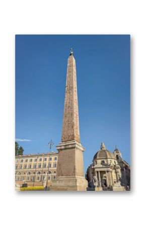 View of the towering Egyptian obelisk in Rome, Piazza del Popolo. The image highlights its ancient hieroglyphs and a classical domed church, all set against a clear blue sky