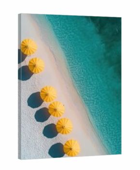 Aerial view of a pristine beach with white sand, clear turquoise water, and a row of bright yellow umbrellas casting shadows