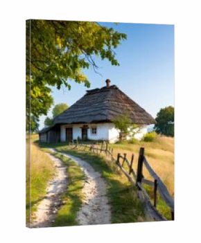 Dirt road leading to traditional ukrainian house with thatched roof