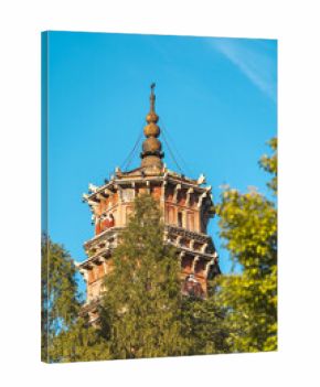 A tall ancient temple tower reaches skyward, its weathered bricks showing detailed architecture under a clear blue sky.Traditional Chinese wooden-structure architecture