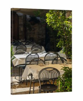 Outdoor Restaurant Tables and Chairs Waiting for Customers in Assisi, Italy