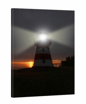 Lighthouse with bright beacon light shining at dusk, silhouetted against dramatic sky and colorful sunset over calm sea, creating a scenic coastal landscape view.