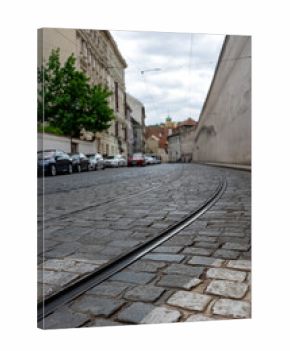 Tram Tracks on Cobblestone Street in Prague.