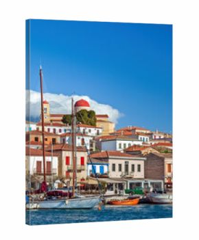 Galaxidi town under tense white clouds, view of the fishing port of this old, traditional village, built by the sea at the Corinthian Gulf, in Greece.