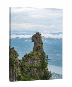 A tall rock formation stands majestically overlooking the landscape of Enshi City, China,