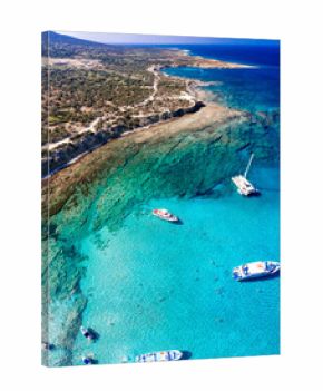 Aerial view of tourists swimming and enjoying the turquoise waters of Chrysochou bay in the blue lagoon, Akamas peninsula, Cyprus