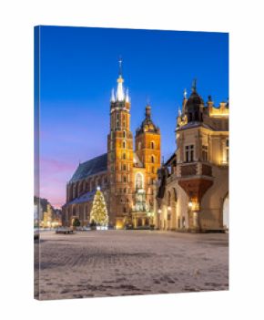 St Mary's church and Cloth Hall fragment on snow covered Main Square in winter Krakow, illuminated in the dawn