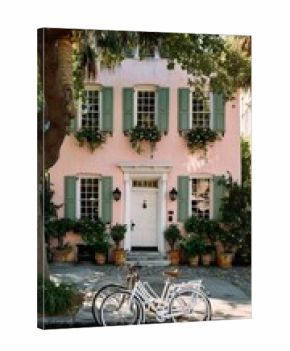 Charming Pastel House With Green Shutters and Bicycles in Front on a Sunny Day