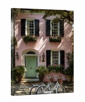 Charming Pastel House With Green Shutters and Bicycles in Front on a Sunny Day