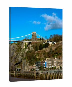 View of the Clifton Suspension Bridge in Bristol, England, with buildings and a river in the foreground.