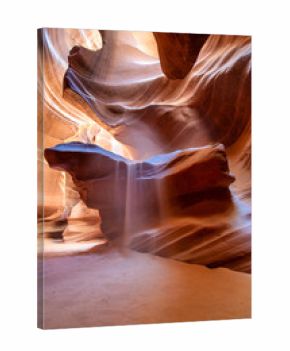 Sunlight creating dramatic patterns on sand and rock formations inside Antelope Canyon