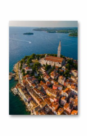 Aerial view of Rovinj, Croatia showcasing colorful homes along the coastline at sunset