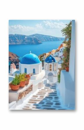 Narrow street leading down to the aegean sea in oia, santorini