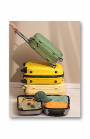 Prepare accessories and travel items with a map on the floor of the suitcase, a woman's hand holding a travel bag