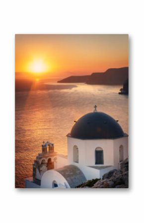 A picturesque church with a blue dome overlooking a stunning sunset over the Aegean Sea