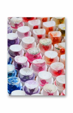A pattern from a many nozzles from a paint sprayer for drawing graffiti, smeared into different colors. The plastic caps are arranged in many rows forming the color of the rainbow