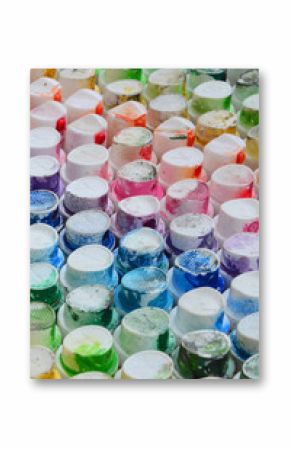 A pattern from a many nozzles from a paint sprayer for drawing graffiti, smeared into different colors. The plastic caps are arranged in many rows forming the color of the rainbow
