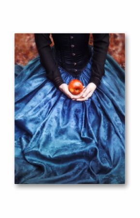 Snow White princess with the famous red apple. Girl holds a ripe