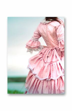 Fairy tale portrait of a beautiful princess woman in medieval era dress with yellow flowers in her hands