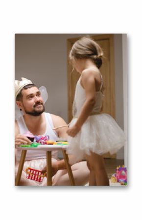 Little daughter and father have fun, dressing in princess costume, daddy makeup