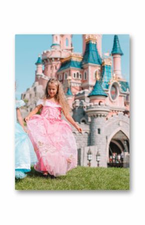 Little adorable girls in beautiful princess dress at fairy-tale park