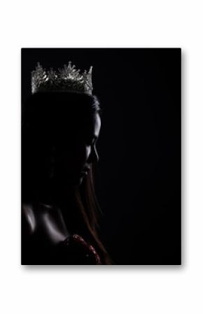 Portrait of Miss Pageant Beauty Contest in sequin Evening Ball Gown long dress with sparkle light Diamond Crown, silhouette low key exposure with curtain, studio lighting dark background dramatic