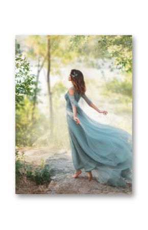 fairy-tale princess in light summer blue turquoise dress on wide path and walks towards wind, graceful dancing girl in image of flower with flying long hem of dress, nymph of bright green forest