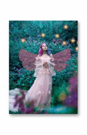 Art photo of a fairy fairy in a pink dress in the forest with fireflies