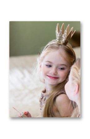The little princess looks in the mirror