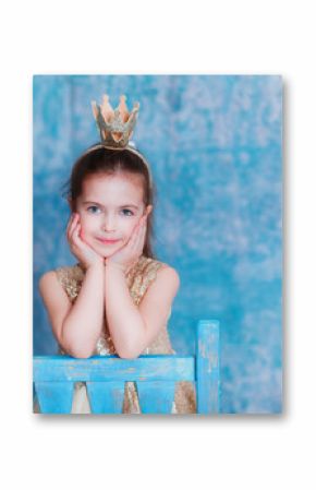 Girl dressed as princess with a crown looking at the camera