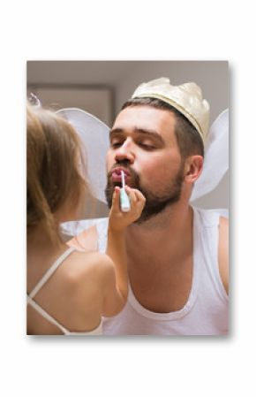 Little daughter and father have fun, dressing in princess costume, daddy makeup