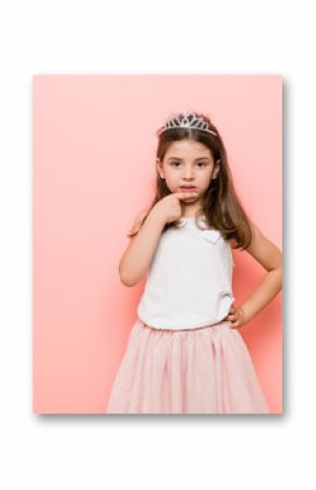 Little girl wearing a princess look biting fingernails, nervous and very anxious.