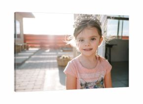 little girl wearing crown outside in sunshine