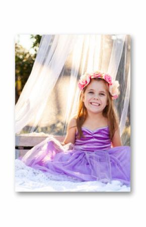 little kid playing imagine game dressed up as princess in purple dress
