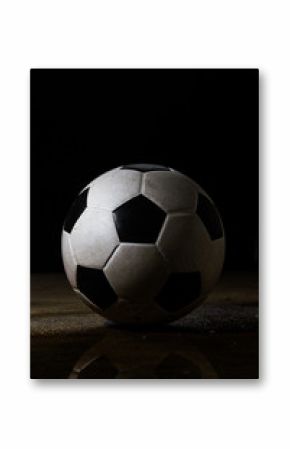 Isolated dirty soccer ball on black bavkground
