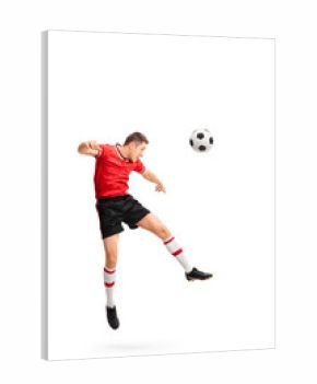 Young football player heading a ball