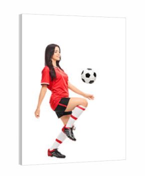 Female soccer player juggling a ball