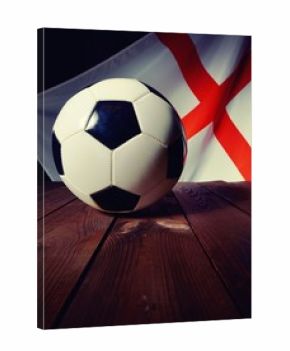 Flag of England with football on wooden boards as the background