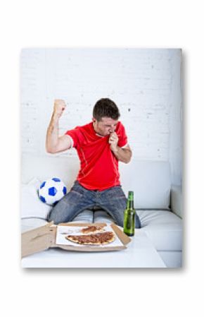 man watching football game on tv in team jersey celebrating goal crazy happy jumping on sofa