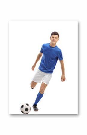 Teenage soccer player kicking a football