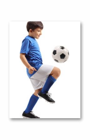 Little footballer juggling a football