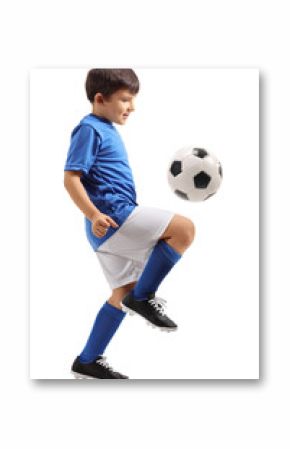 Little footballer juggling a football