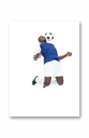 Football player in blue jersey controlling ball