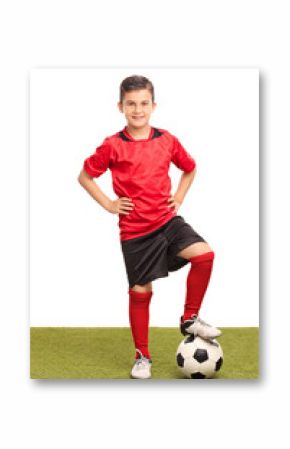 Junior soccer player stepping over a ball