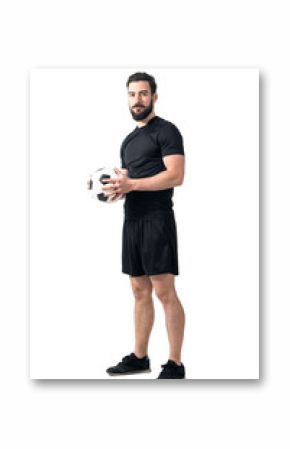 Confident futsal or football player holding ball with both hands looking at camera. Full body length portrait isolated over white background.