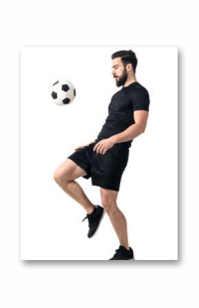 Side view of football or futsal player juggling ball with his knee. Full body length portrait isolated over white background.