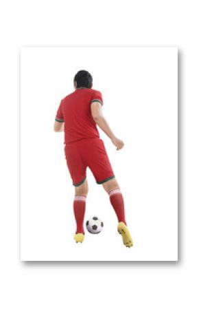 Back view of asian football player kick ball